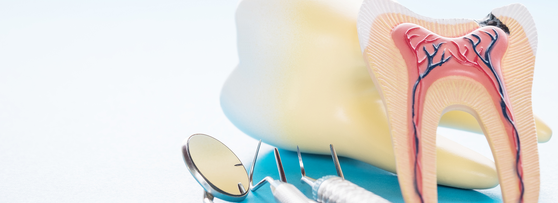 The image displays a pair of yellow toothbrushes with red bristles, placed next to each other against a white background.